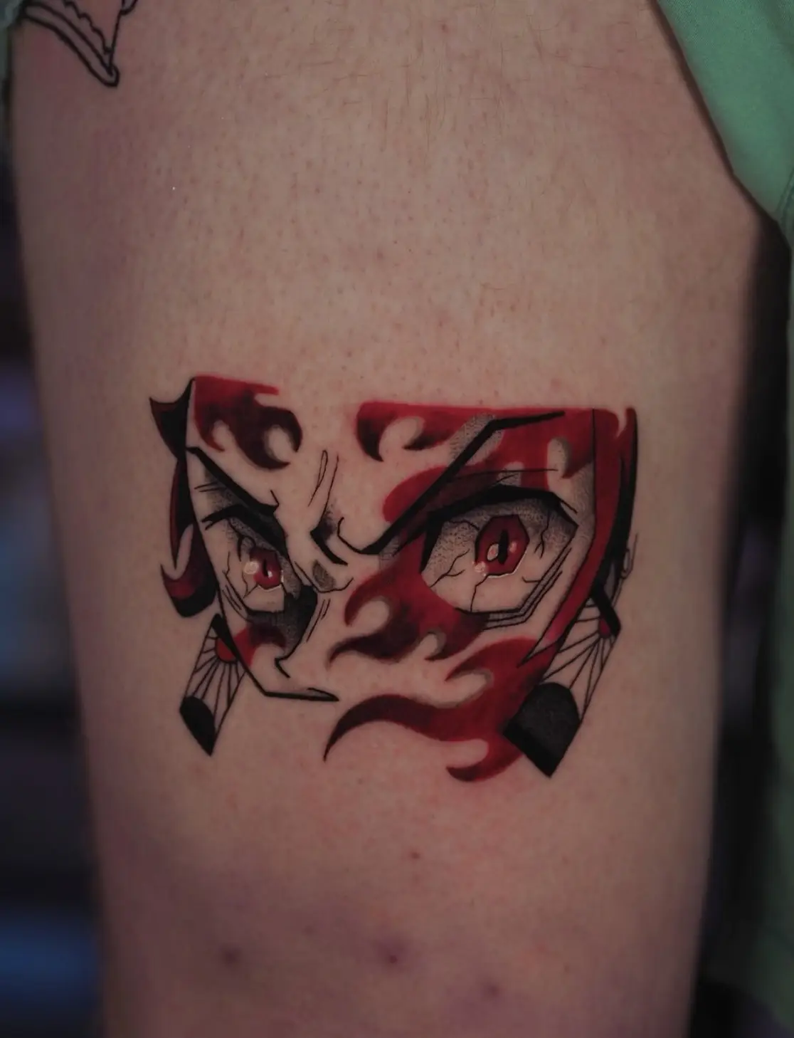 Demon slayer inspired tattoo with mask and red accent details by Sara at Omnia Tattoo Melbourne